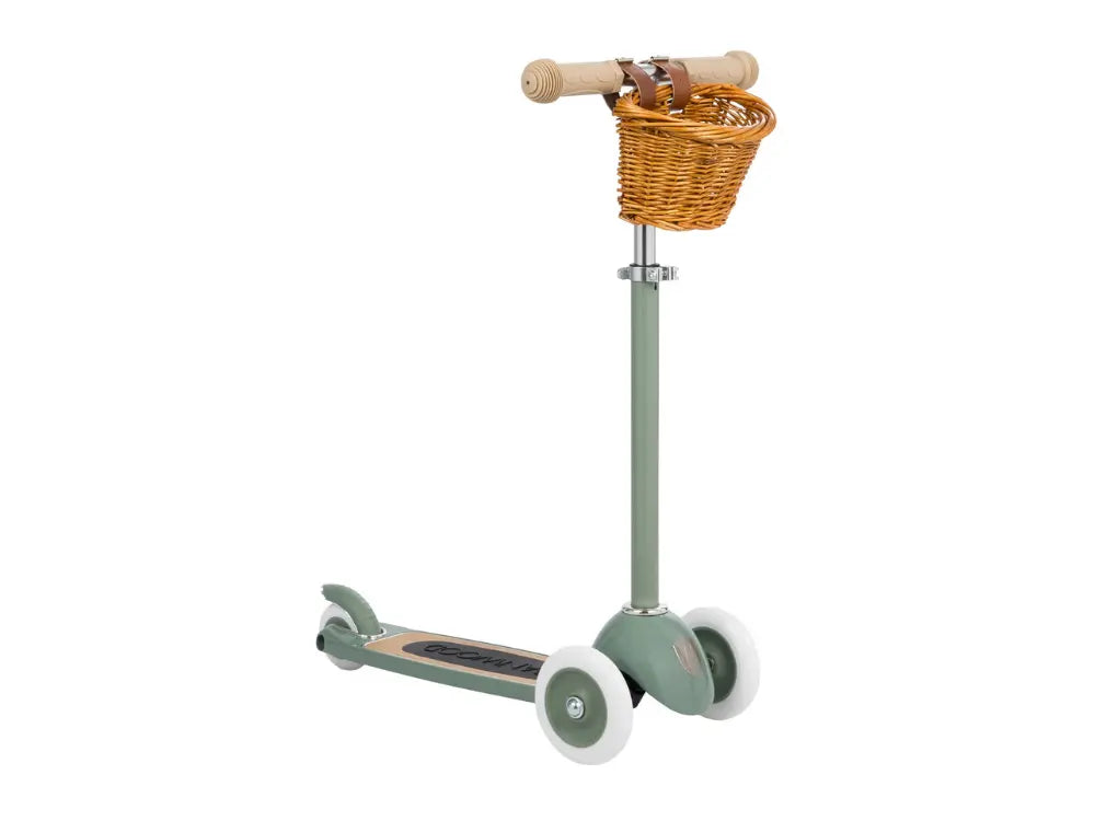 Green children's scooter with a wicker basket on a white background