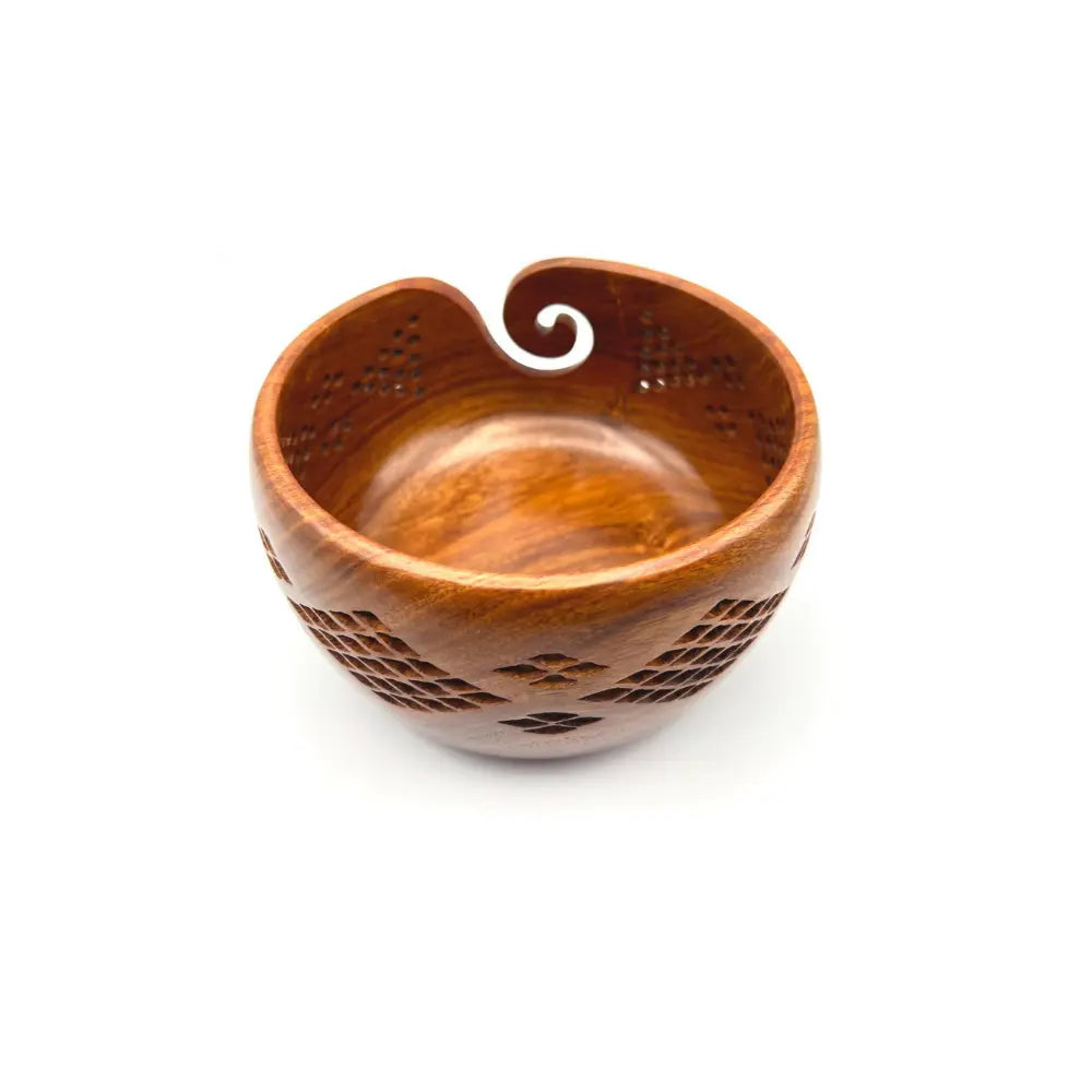 Wooden bowl with decorative patterns on a white background