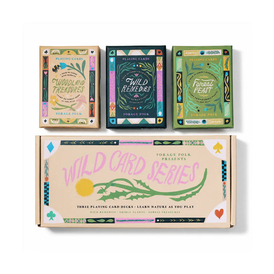 Three Forage Folk playing card decks and their illustrated boxes arranged on a white background. 