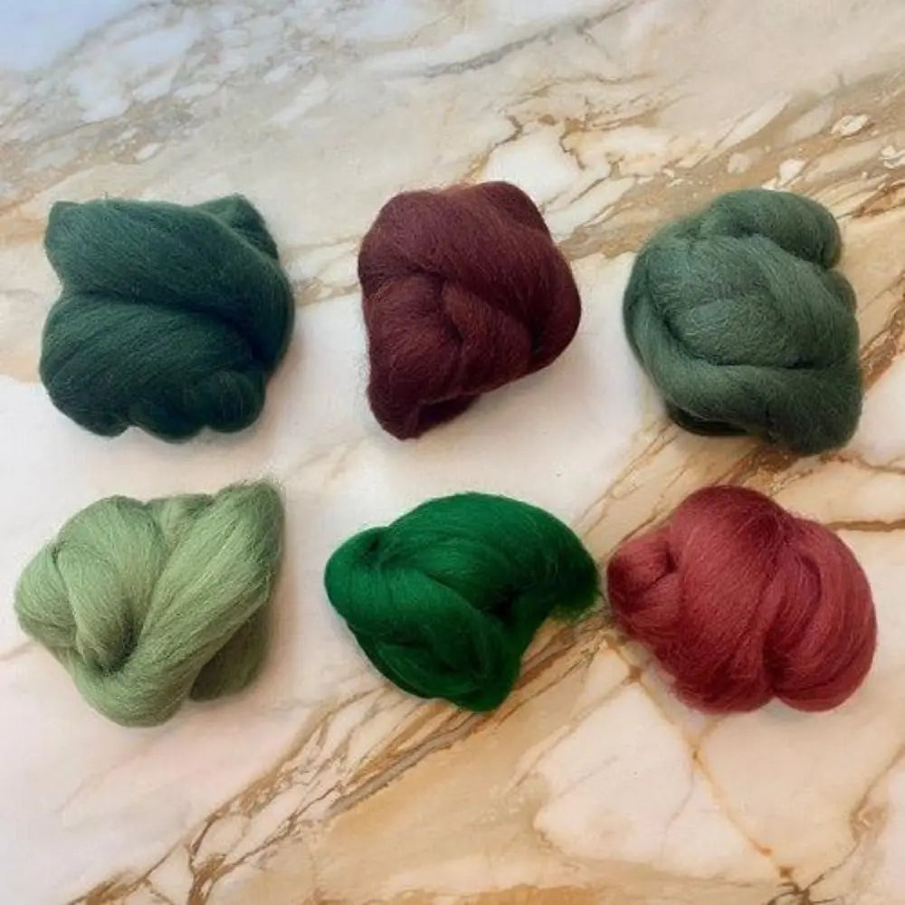 six skeins of Forest Plum wool top color bundle for spinning and felting on marble