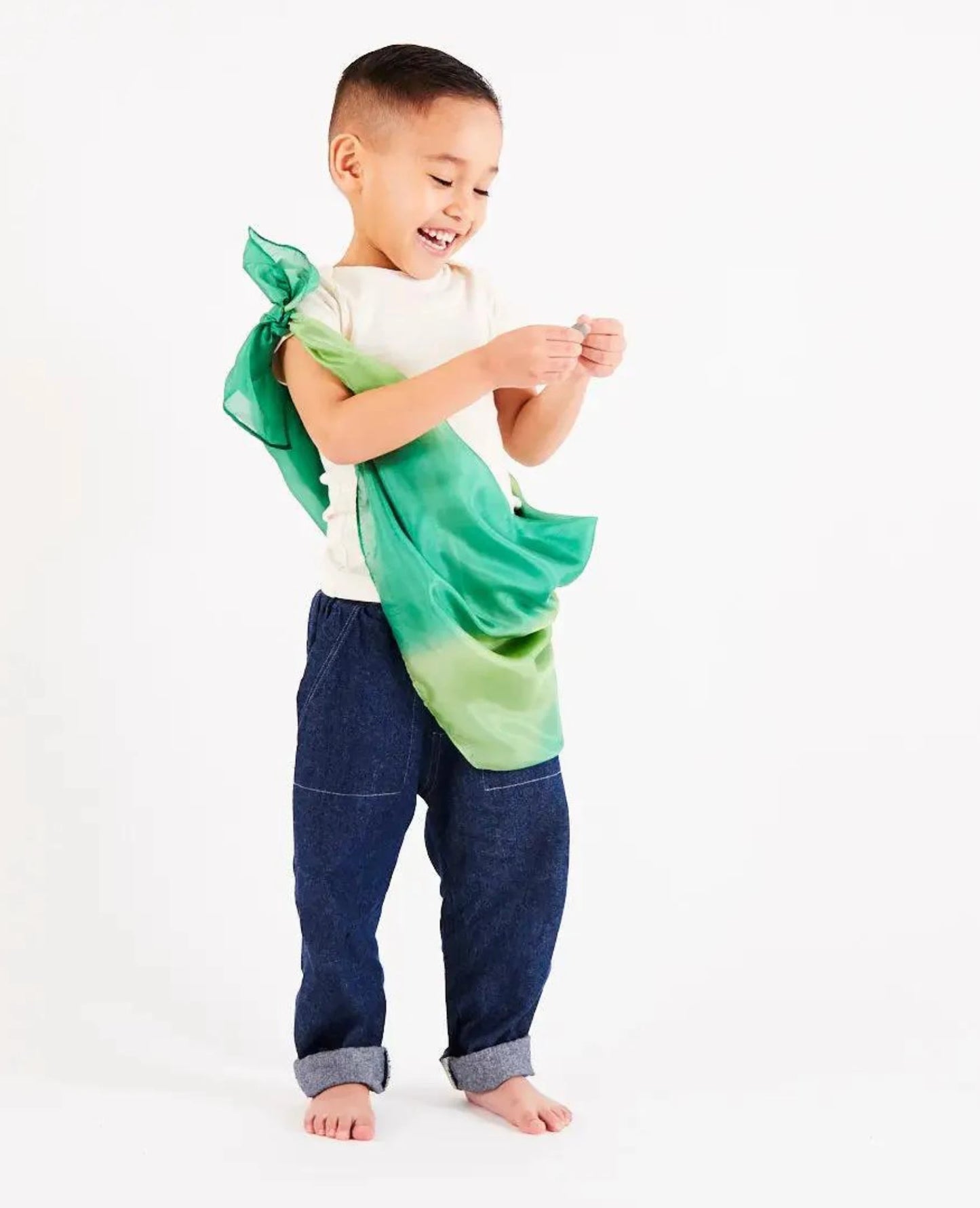 boy wearing a forest colorway Earth playsilk as a tunic