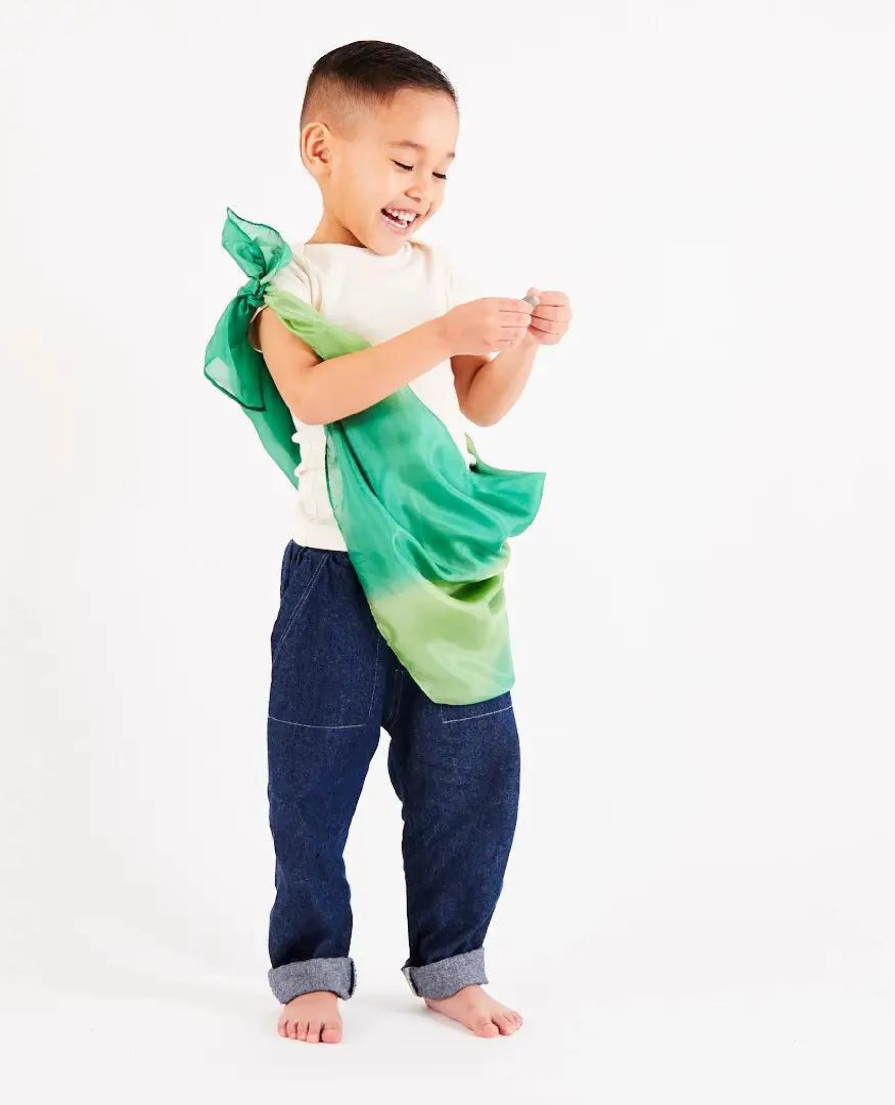 boy wearing a forest colorway Earth playsilk as a tunic