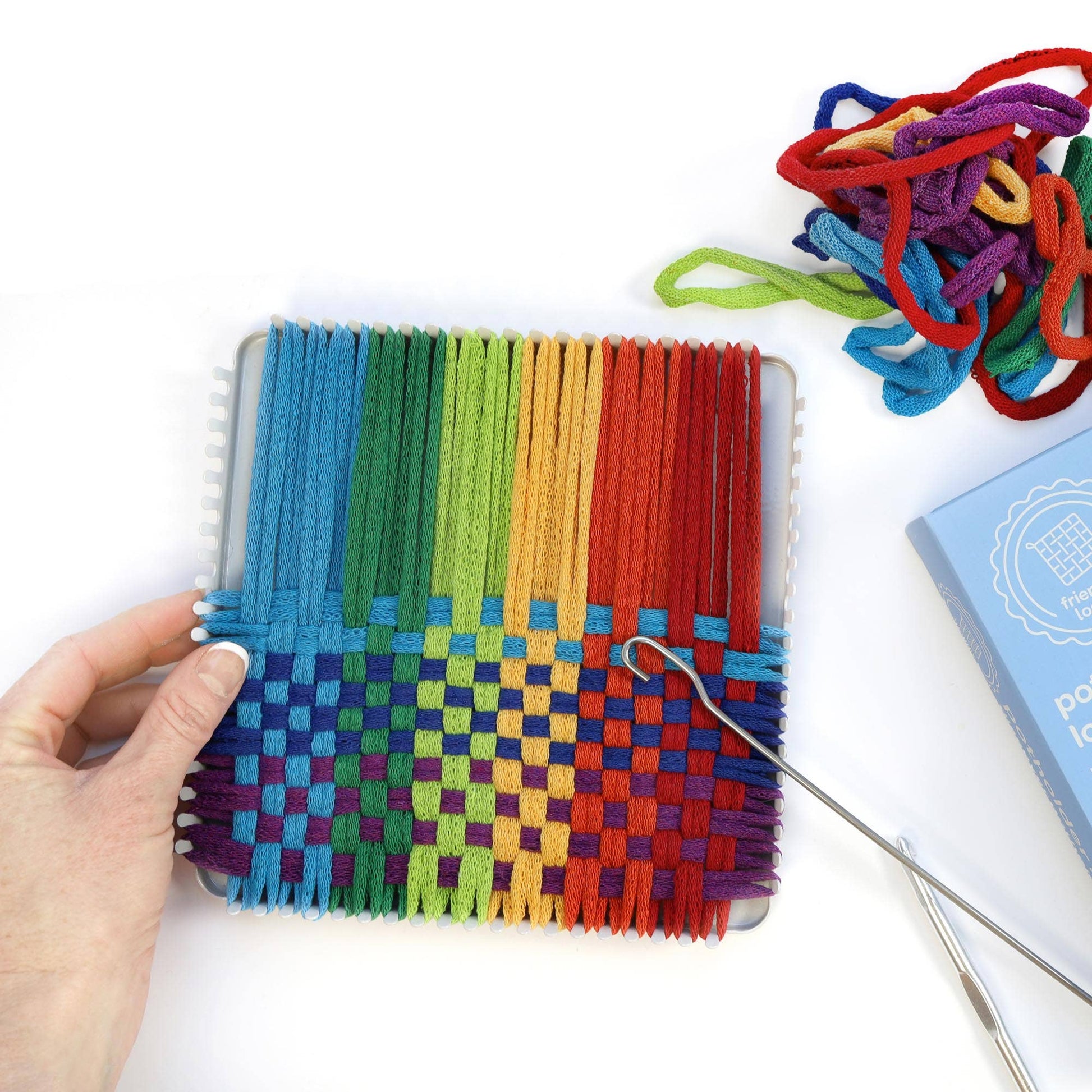 Colorful cotton potholder weaving in progress on a Friendly Loom metal potholder loom