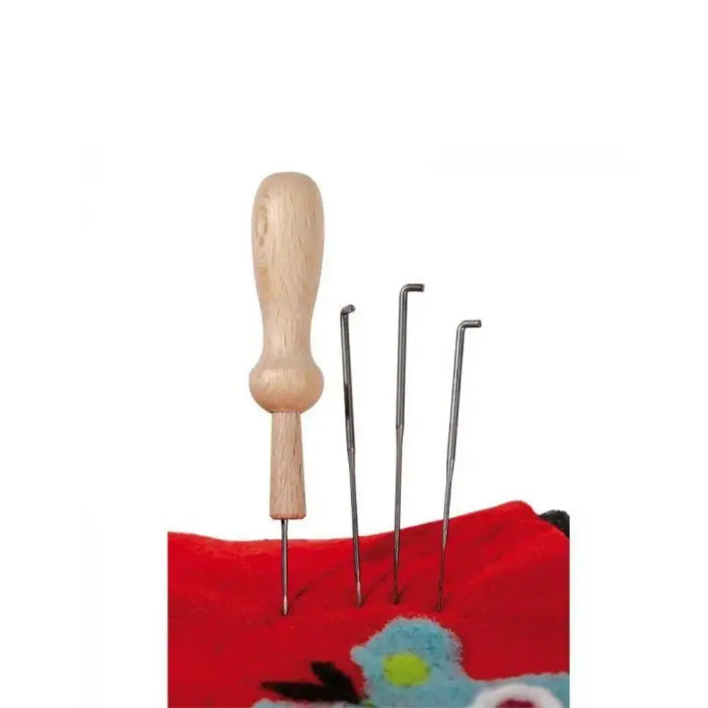 Set of felting needles with wooden handle on a red fabric background