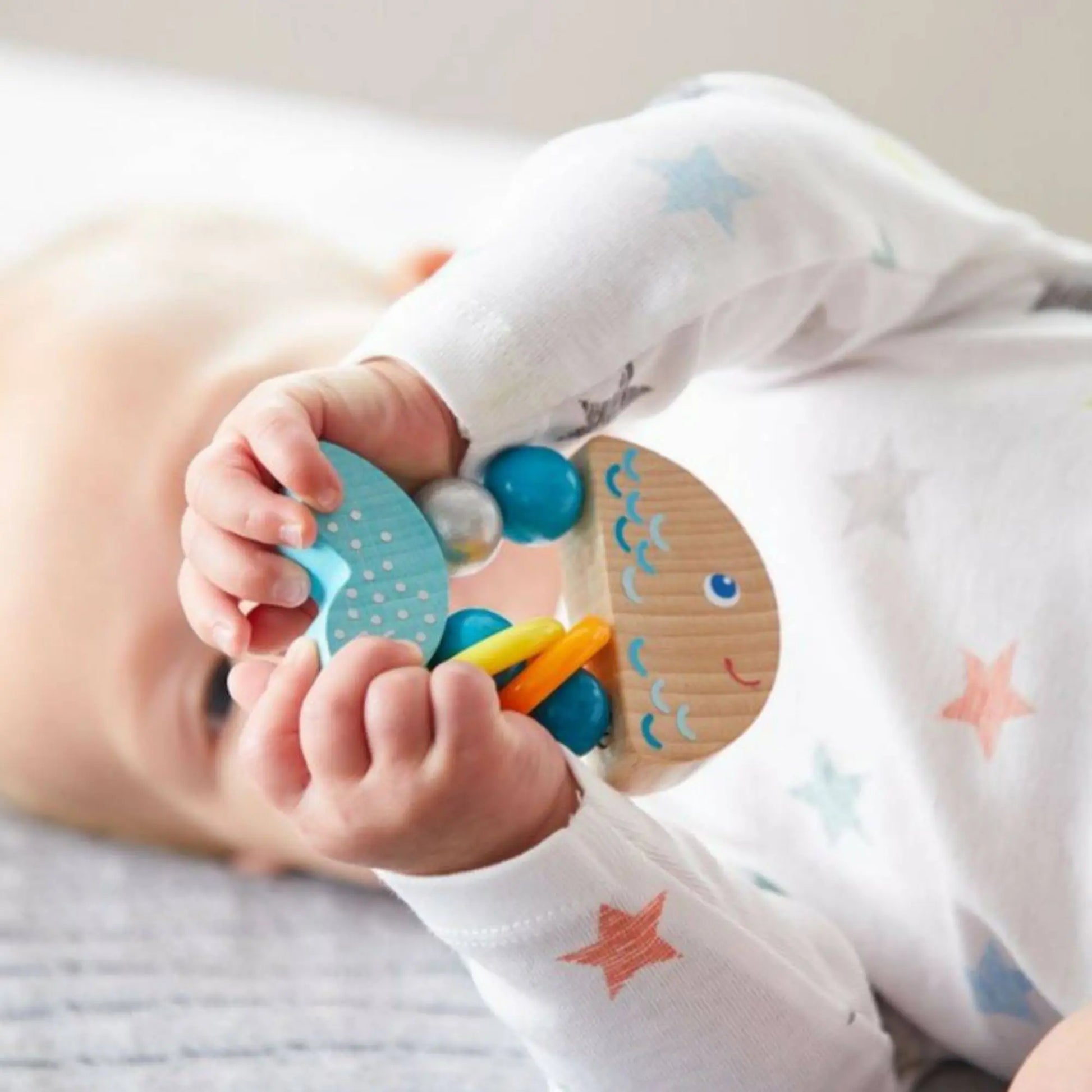 Baby playing with a colorful wooden toy