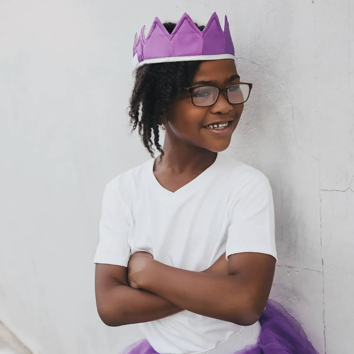 Child wearing a purple satin crown