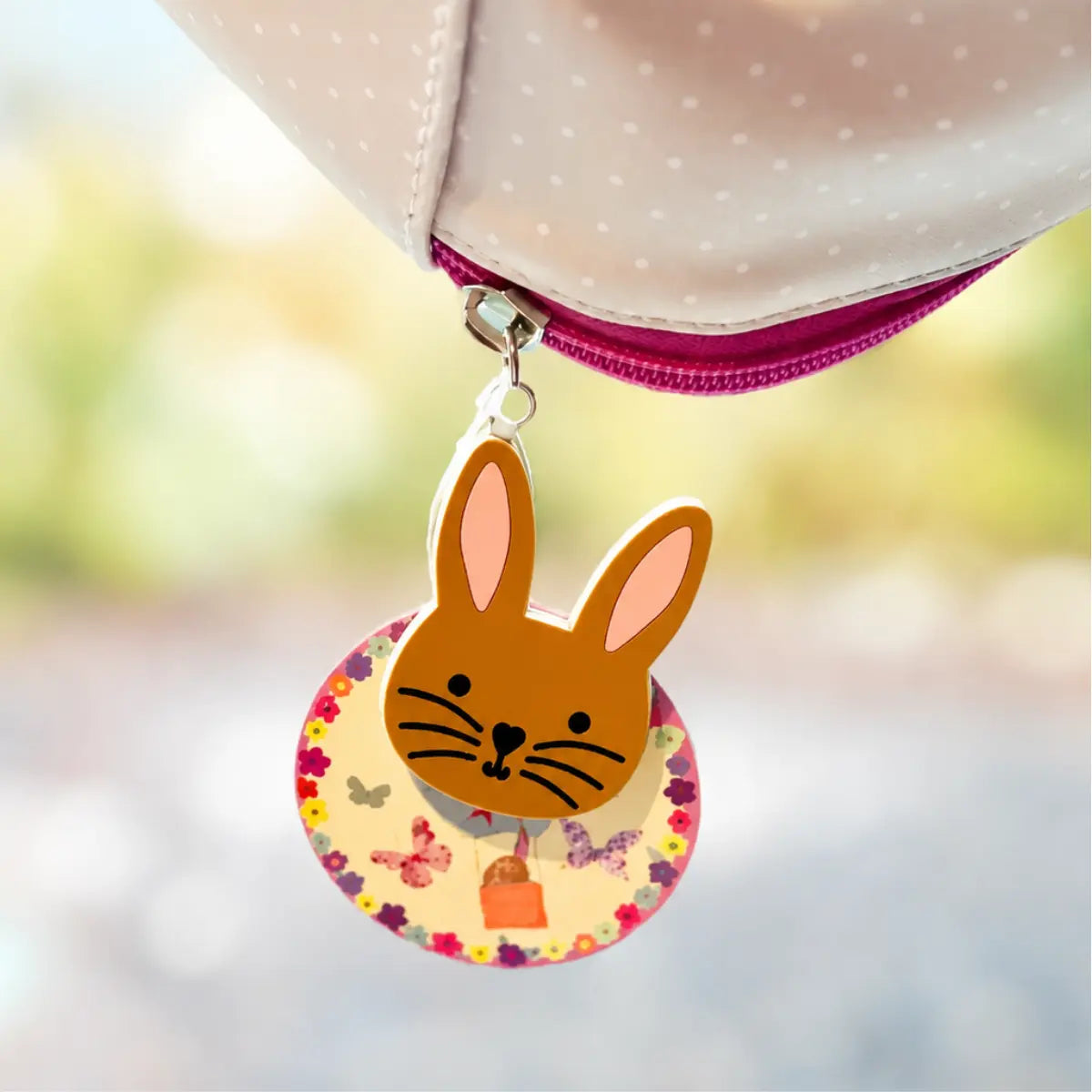 Bunny zipper charm attached to the pink zipper of the girls insulated lunch bag