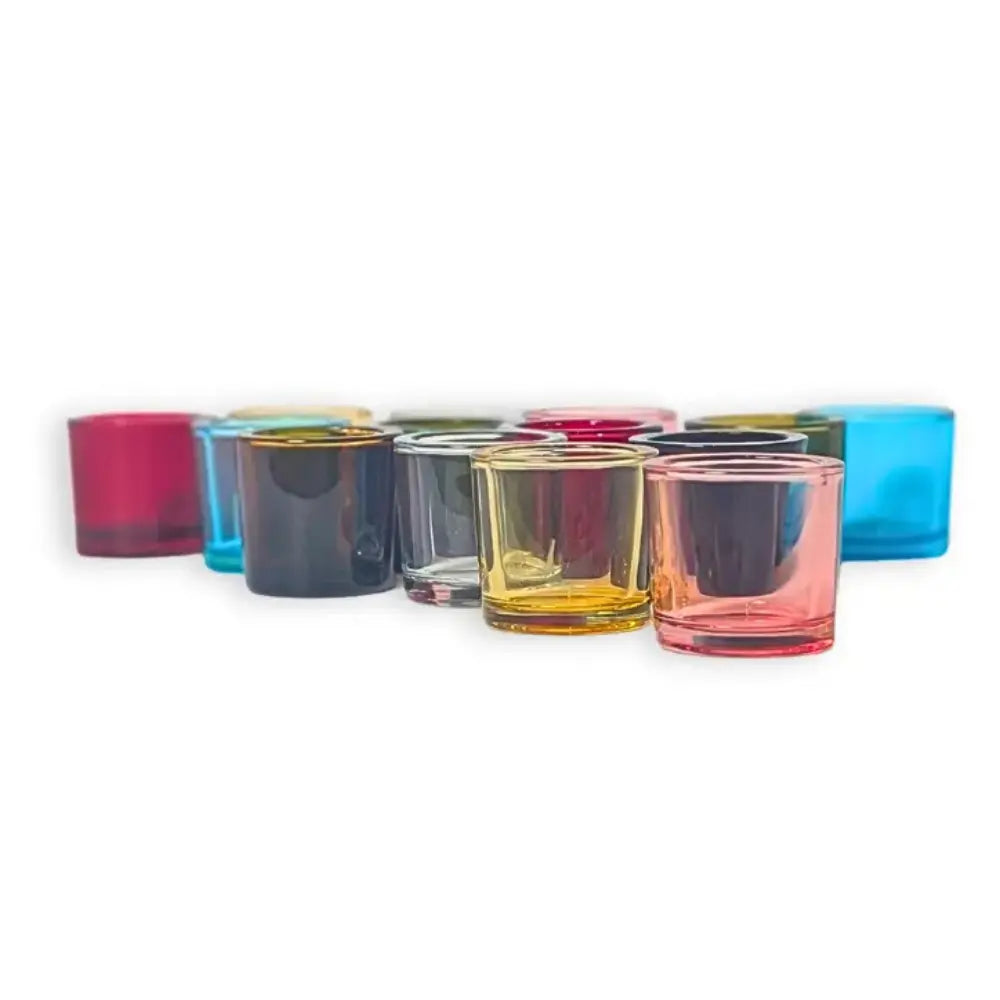 Set of colorful glass candle holders on a white background