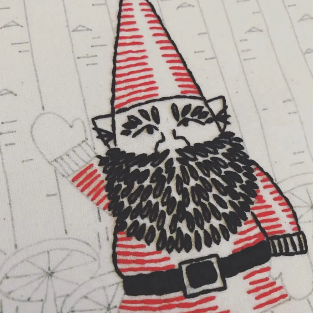Close-up of preprinted gnome embroidery pattern on fabric