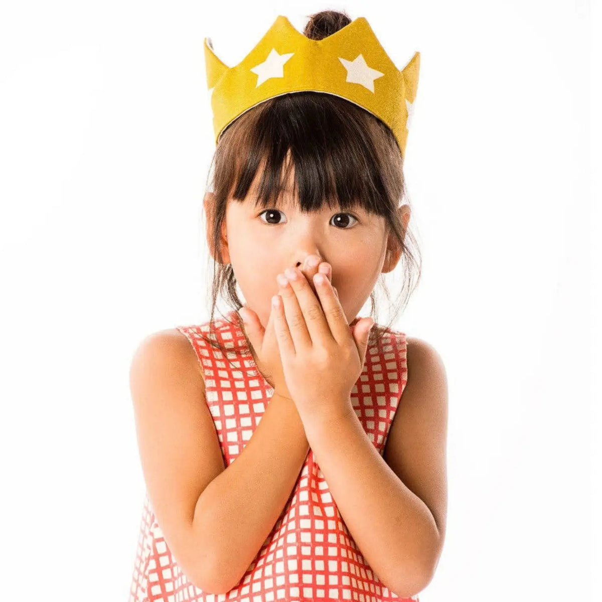 Child wearing a gold cotton canvas star dress-up crown