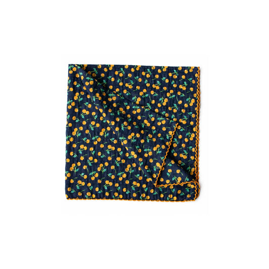 Golden Cherry reusable lunch napkin in navy blue with a small golden cherry print and orange decorative edging on a white background