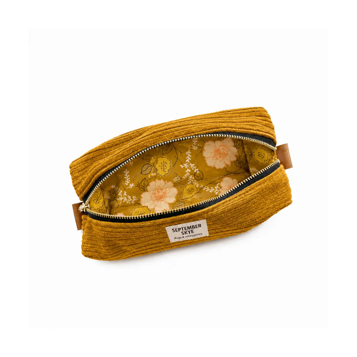 A mustard yellow corduroy pen and pencil pouch with an open zipper, showing a floral patterned lining.