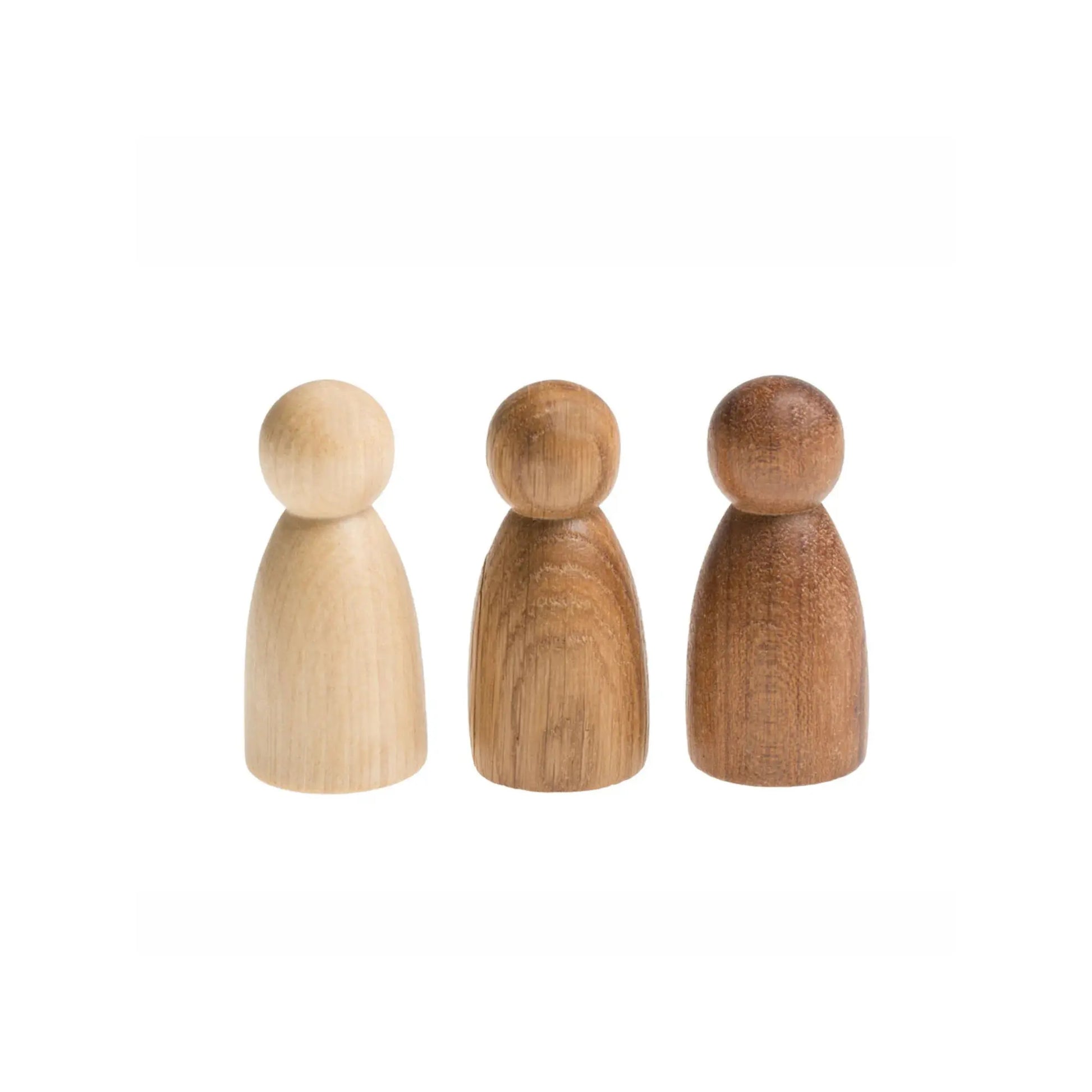 Three wooden peg dolls of different wood tones on a white background