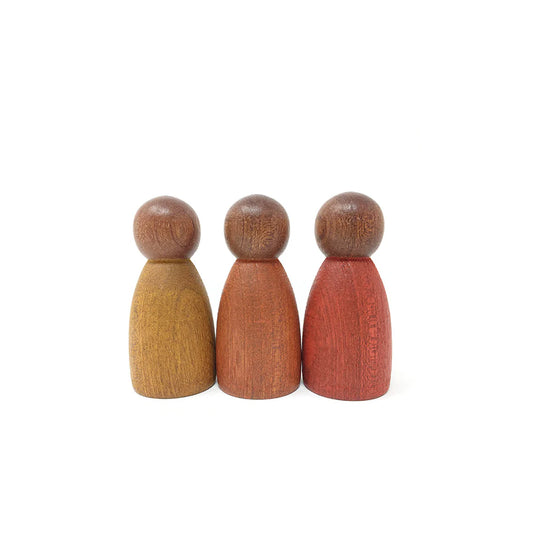 Three wooden peg dolls in different colors on a white background