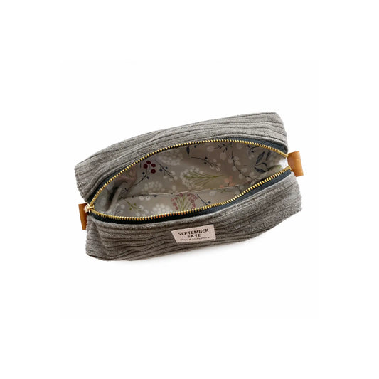 Open gray corduroy pencil pouch showing botanical-print lining and roomy interior