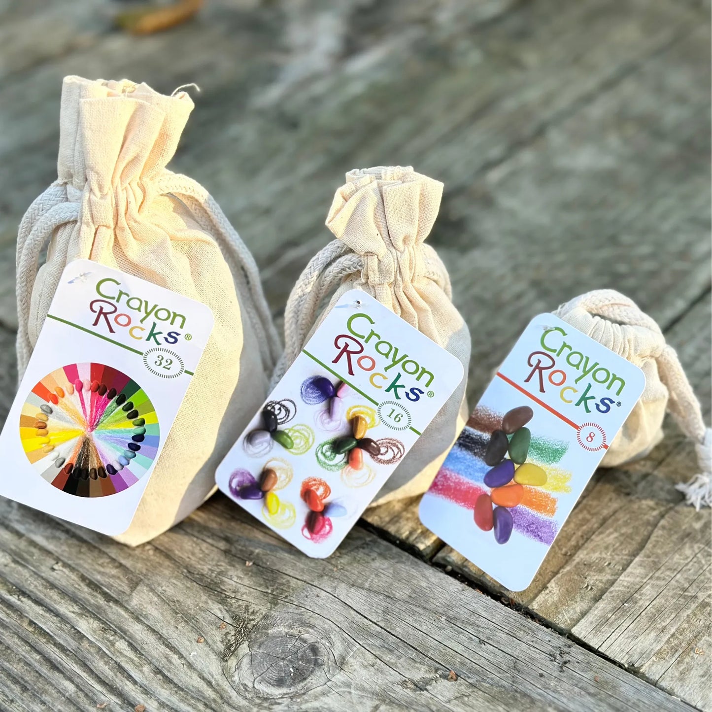 soy wax grip training crayons in cotton bags showing 8, 16, and 32 color sets for fine motor development