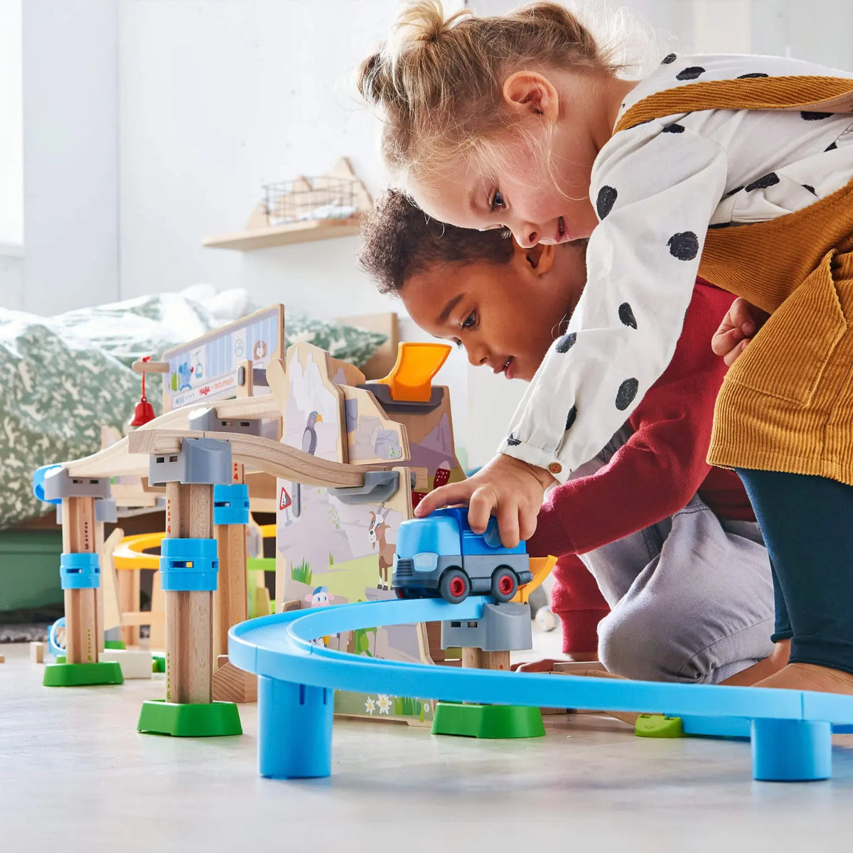 Children building and playing with the HABA Kullerbü Mountain Adventure Track Set