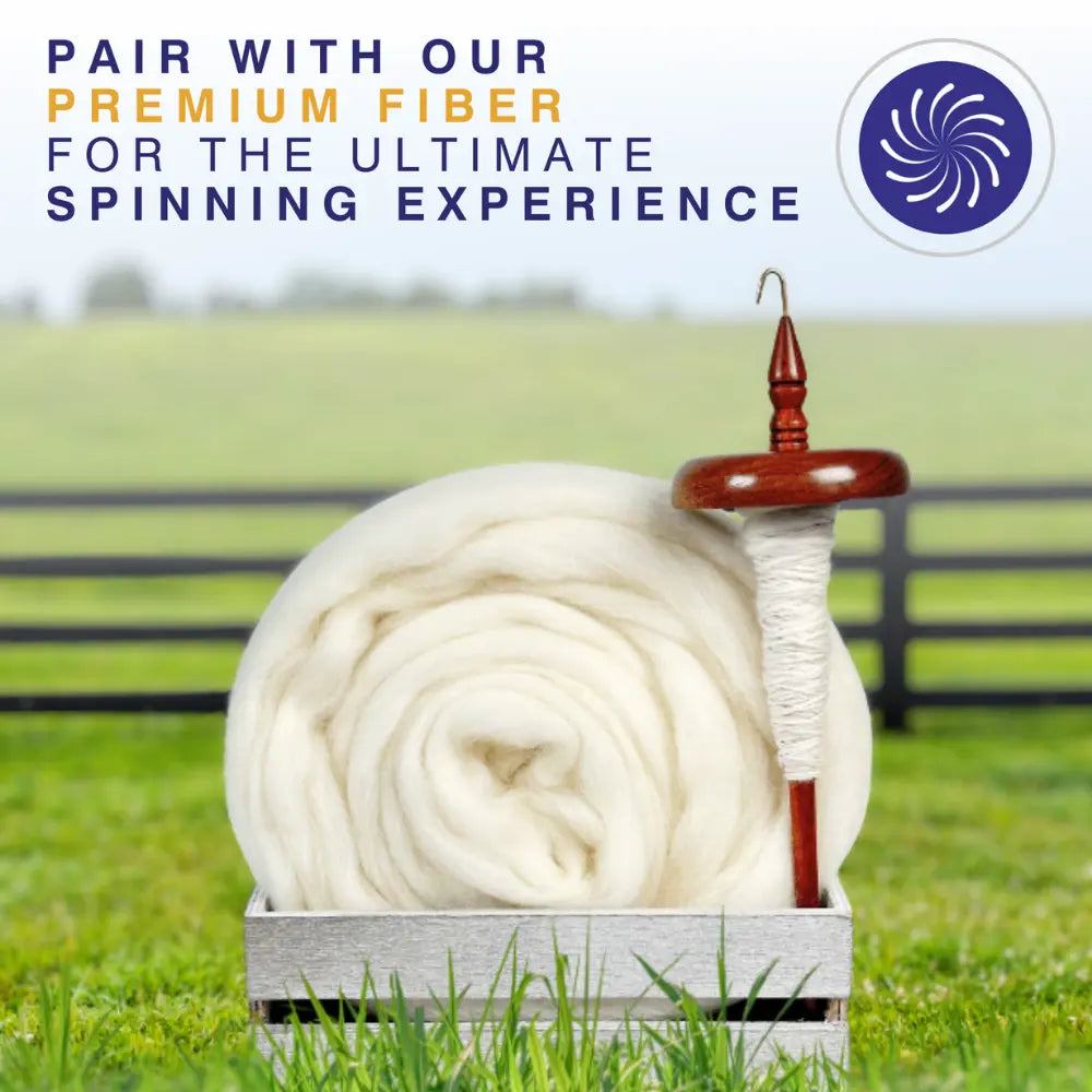 Wooden top whorl drop spindle with white yarn on a white background