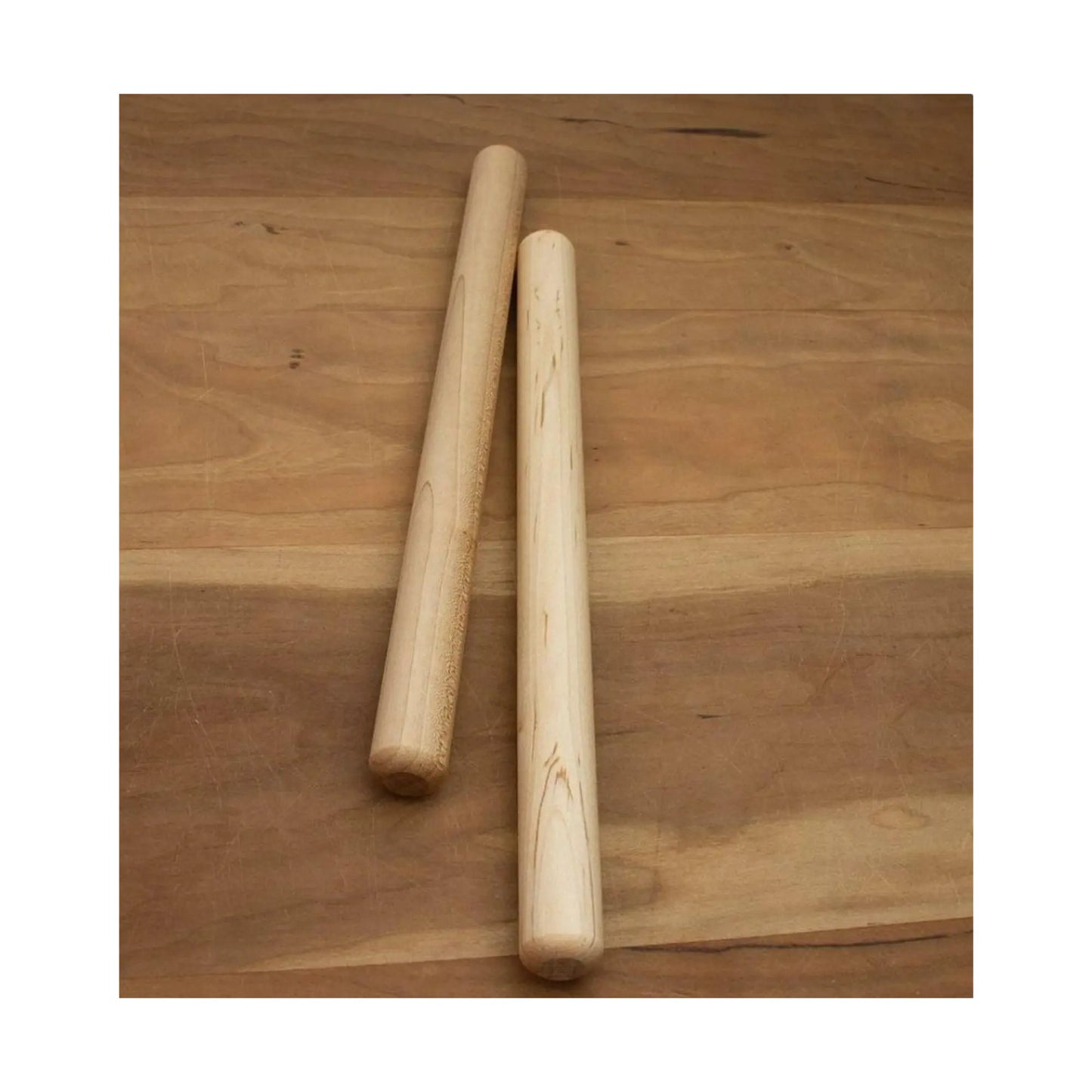 Pair of wooden rhythm sticks on wood surface for circle time and music lessons