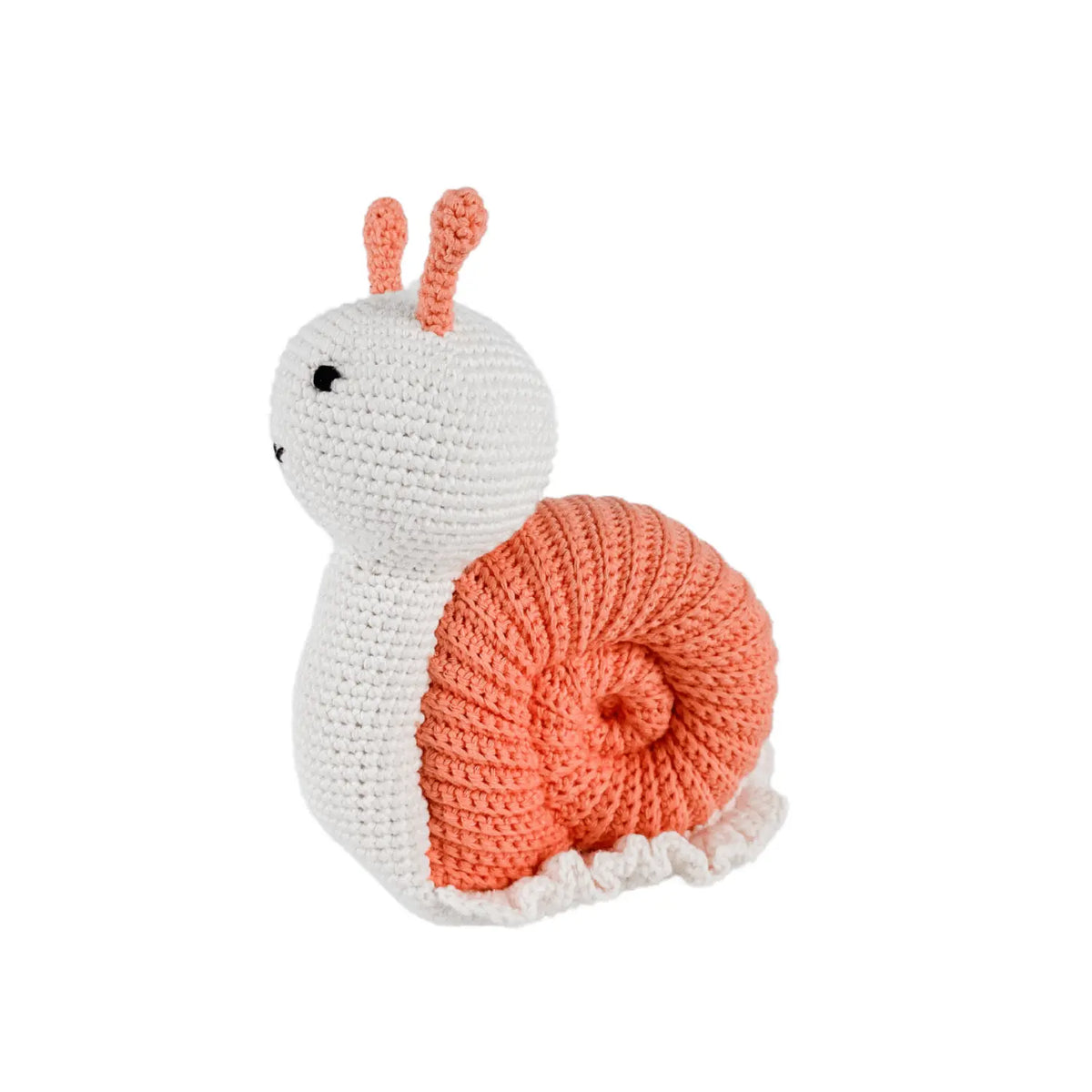 Hand-crocheted organic cotton snail toy with a coiled peach shell, shown at a three-quarter angle