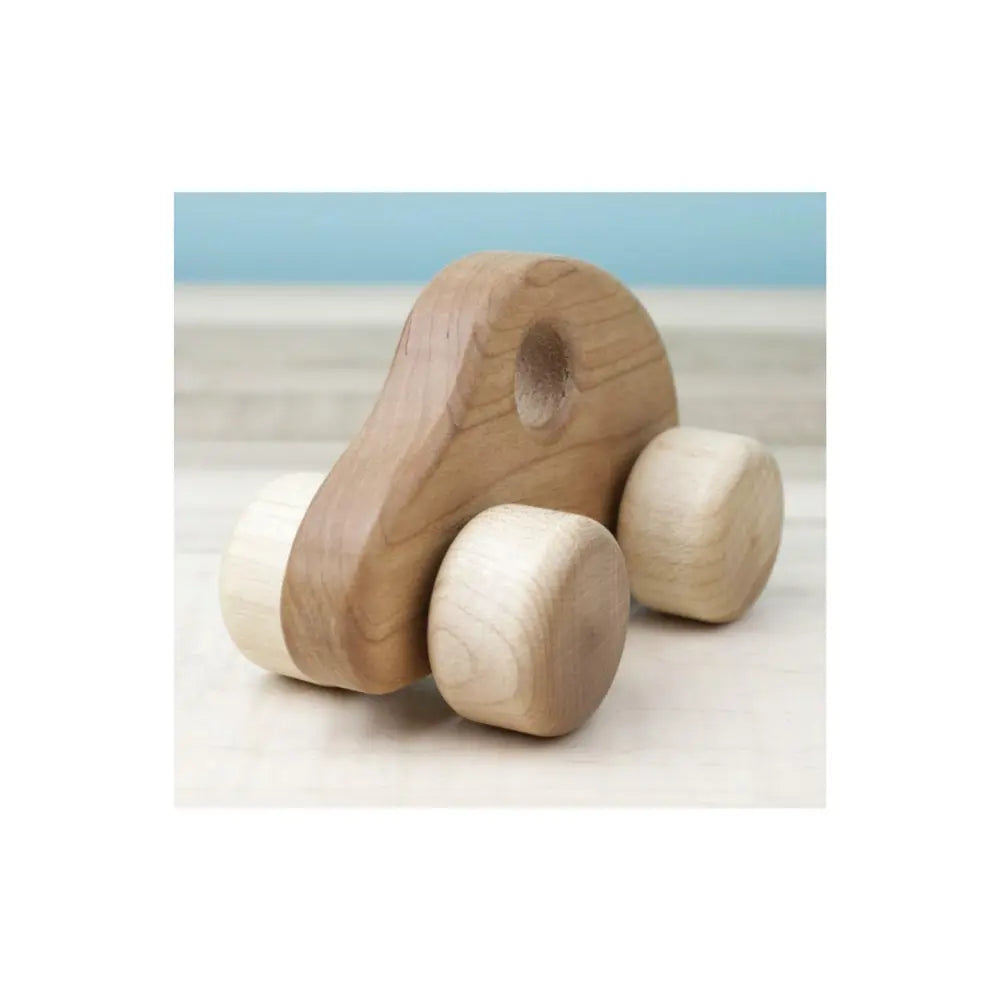 Handmade wooden car showing smooth cherry wood body and easy-grip window