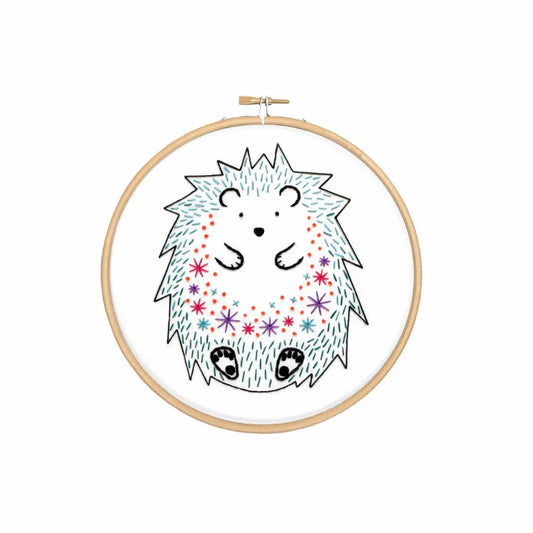 Embroidery hoop with a cartoon hedgehog design on a white background