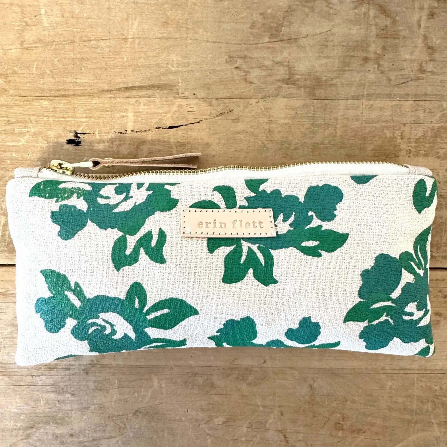 Helen Rose Green cotton barkcloth pencil pouch by Erin Flett on a rustic wood background