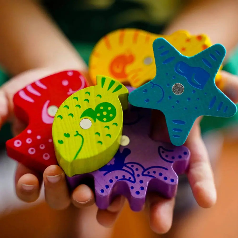 Close-up of wooden fish pieces from Here Fishy Fishy toddler game