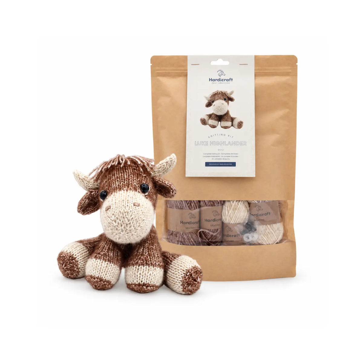 Hardicraft Luke Highlander DIY knitting kit shown with the finished knitted Highland cow