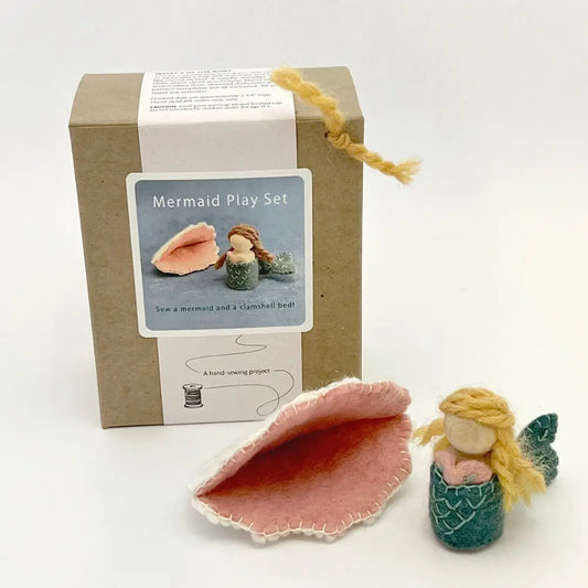 Mermaid peg doll craft set with a box and pink shell on a white background
