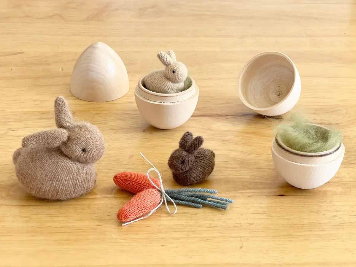Hand sewn cashmere rabbit and wooden items on a wooden surface