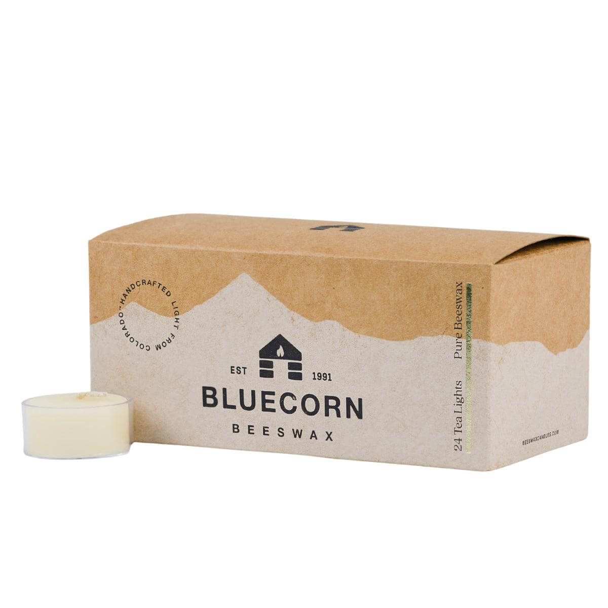 Box of Bluecorn Beeswax candles with a single candle in front on a white background