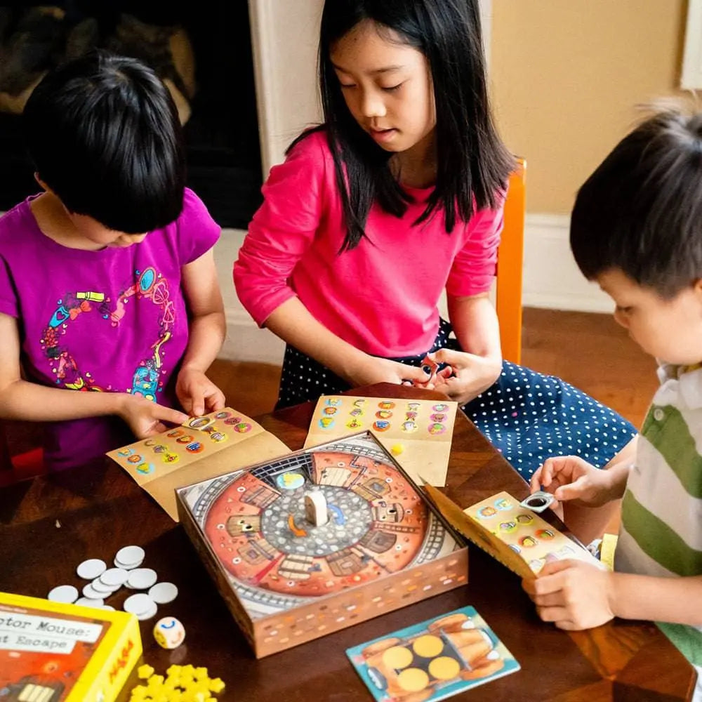 Children playing Inspector Mouse memory and deduction game at table