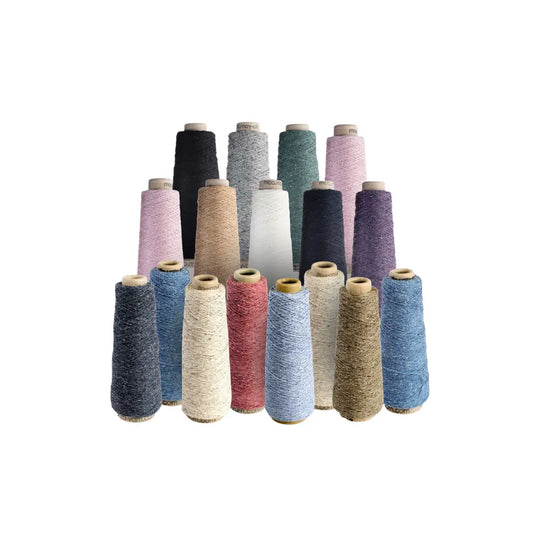 Assorted colored silk noil yarn cones on a white background