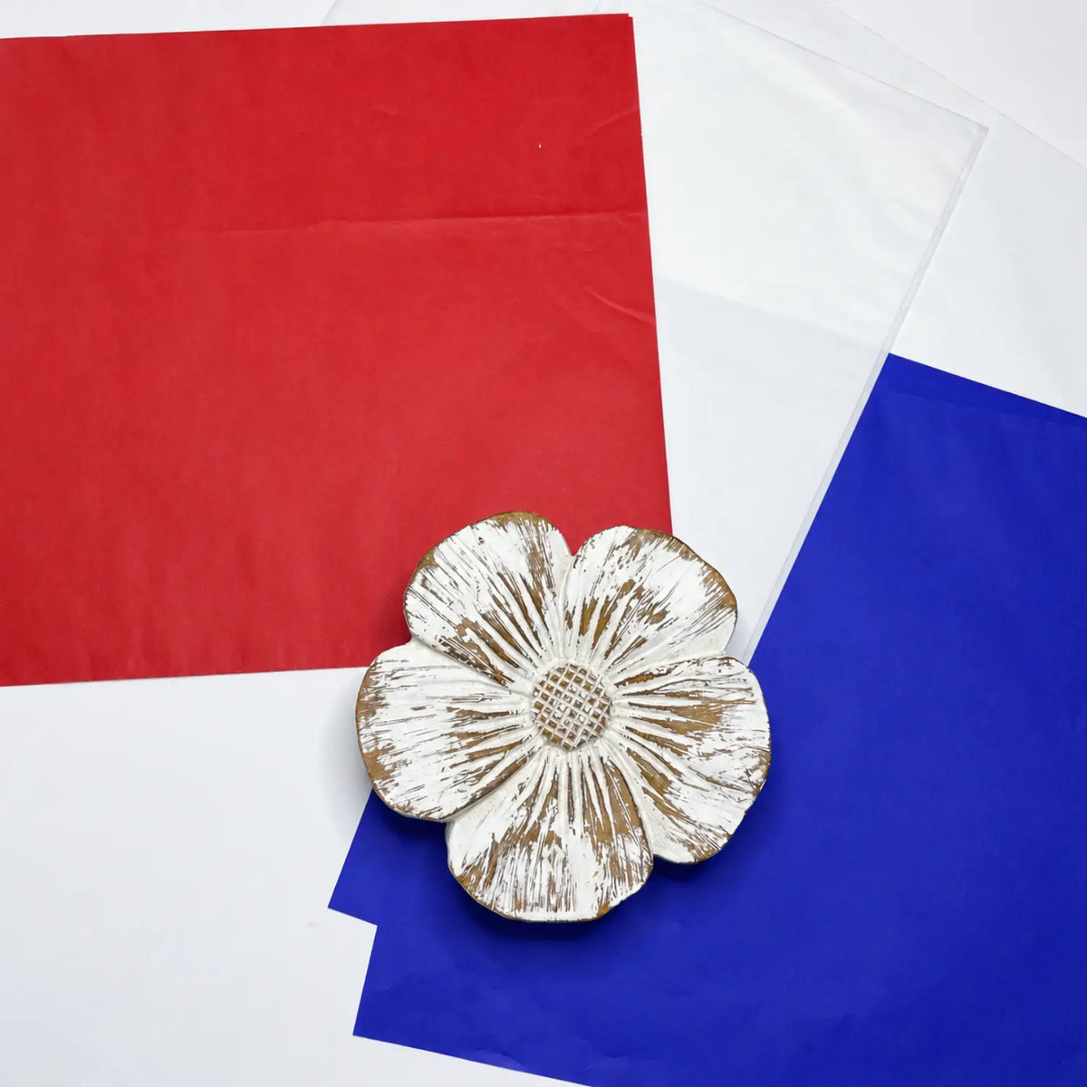 Red, white, and blue Japanese silk paper arranged for a Fourth of July craft