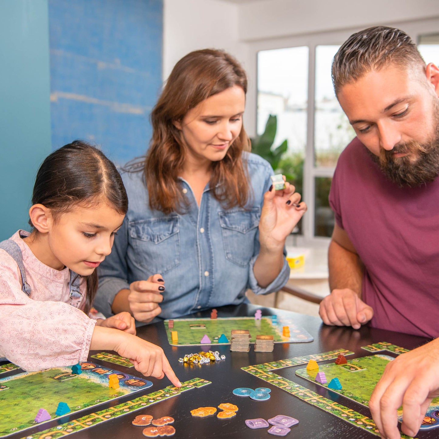 Family playing a board game together in a home setting