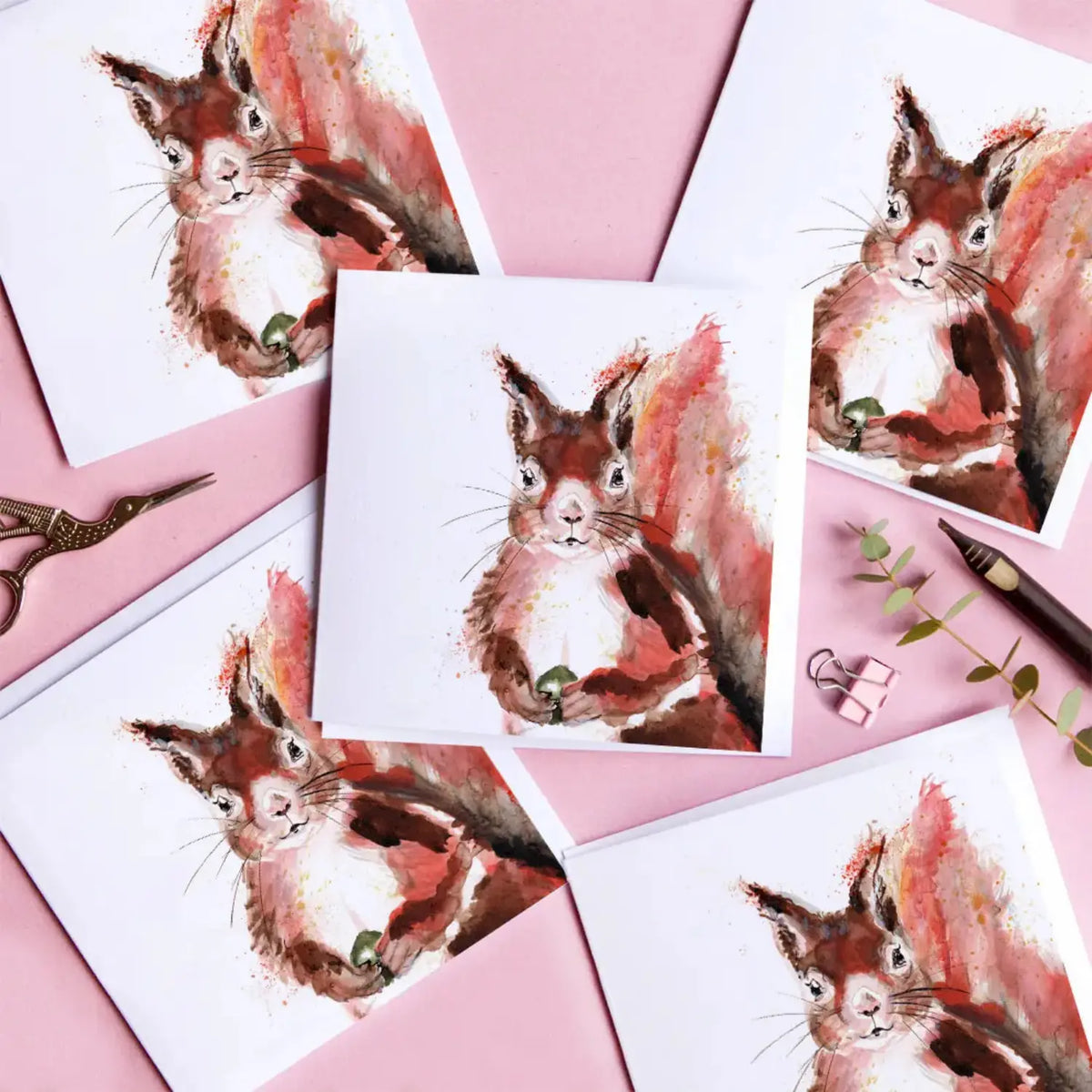 Kate Moby red squirrel greeting cards arranged on a pink background with stationery details