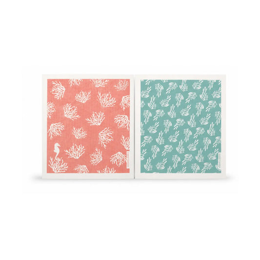 Set of two reusable Swedish dishcloths in coral pink and blue-green kelp designs on a white background
