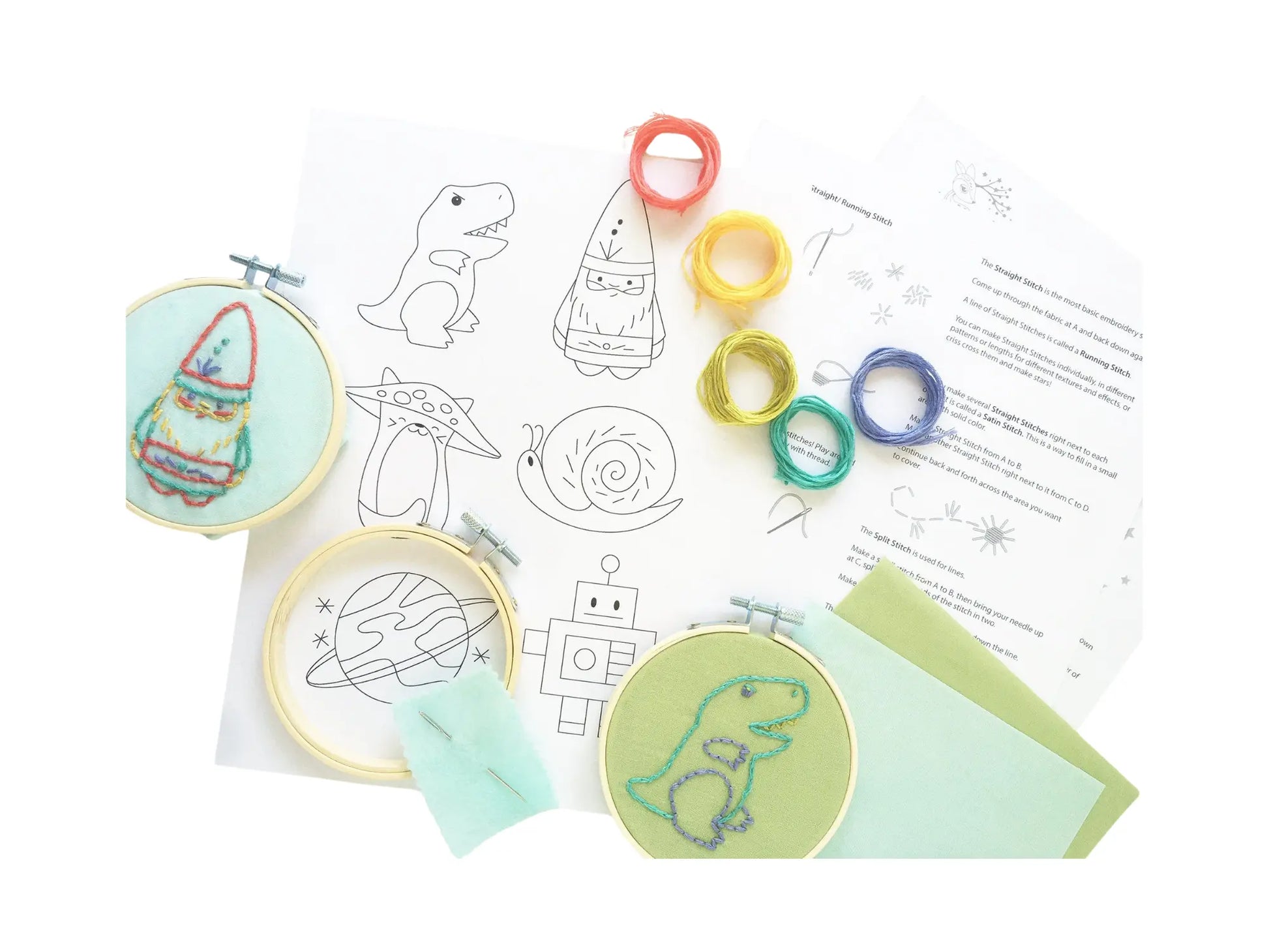 Kids embroidery kit with pre-printed designs, hoops, and materials on a white background