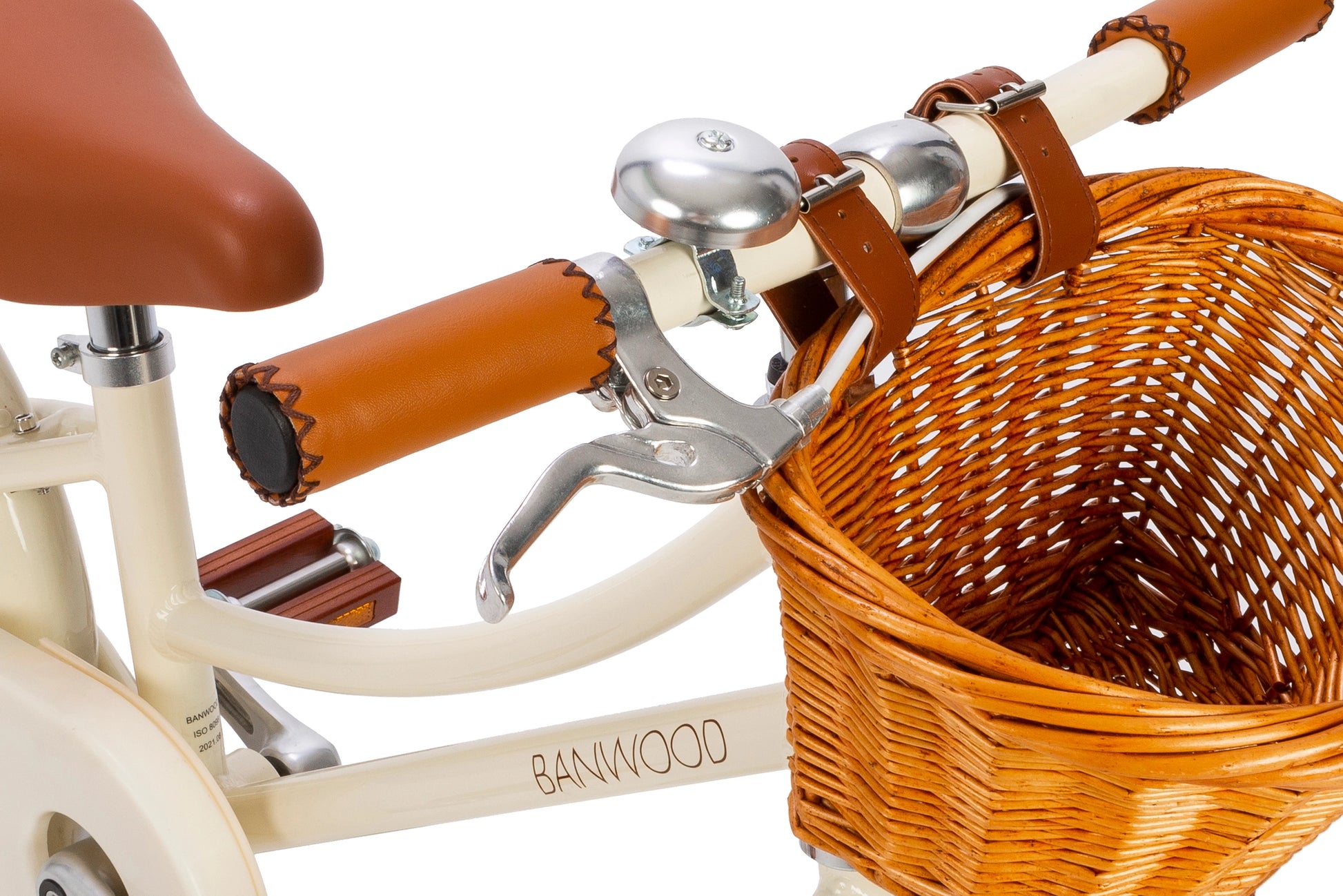 Close-up of a tricycle with a wicker basket, handlebars, and seat on a white background.