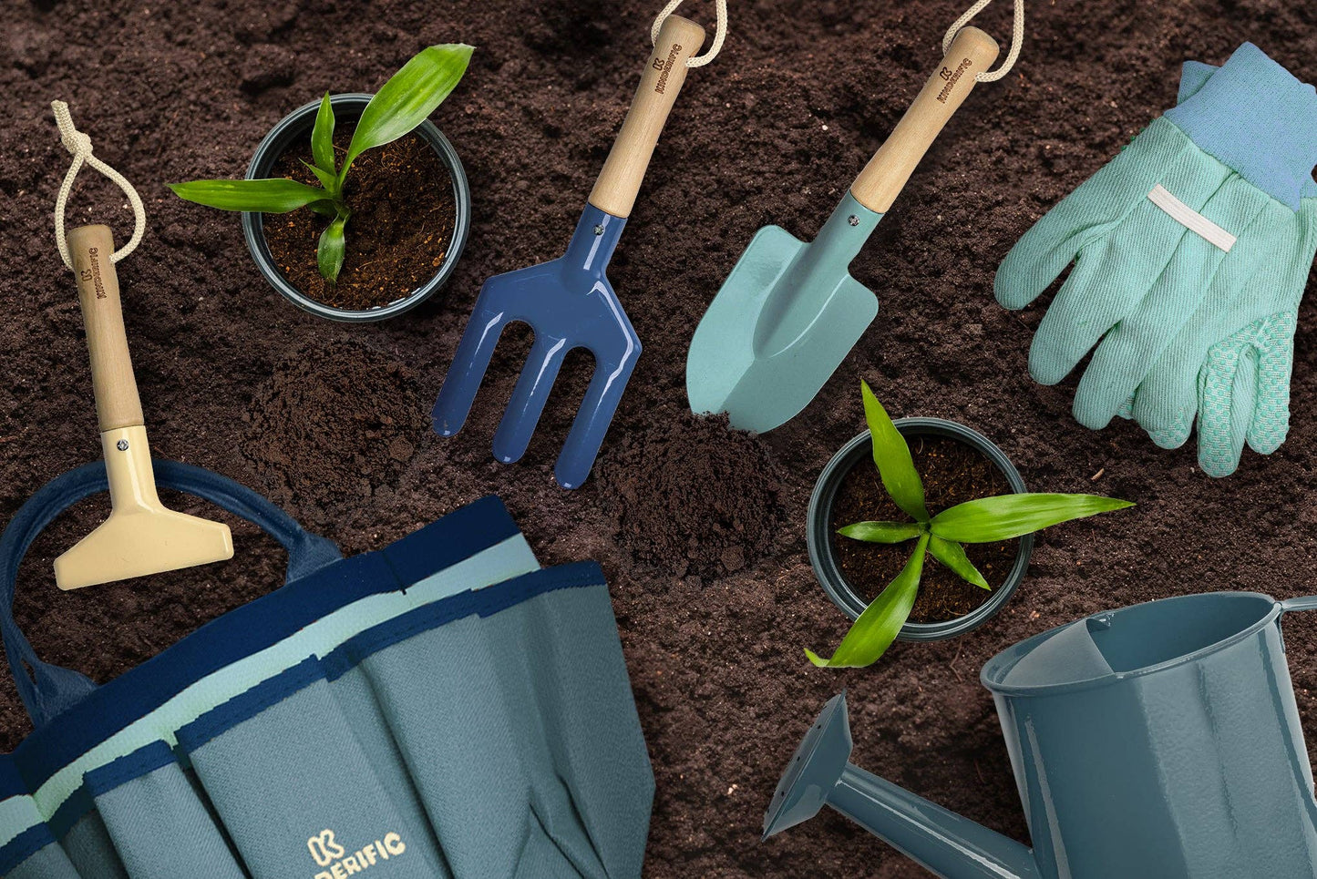 children’s gardening tools in soil with plants and gloves