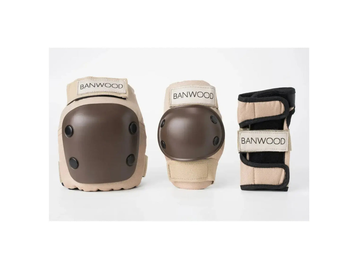 A set of Banwood protective gear including a knee pad, elbow pad, and wrist guard in beige and brown, displayed against a clean white background.