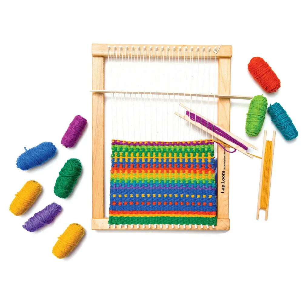 Small wooden loom with colorful yarn on a white background