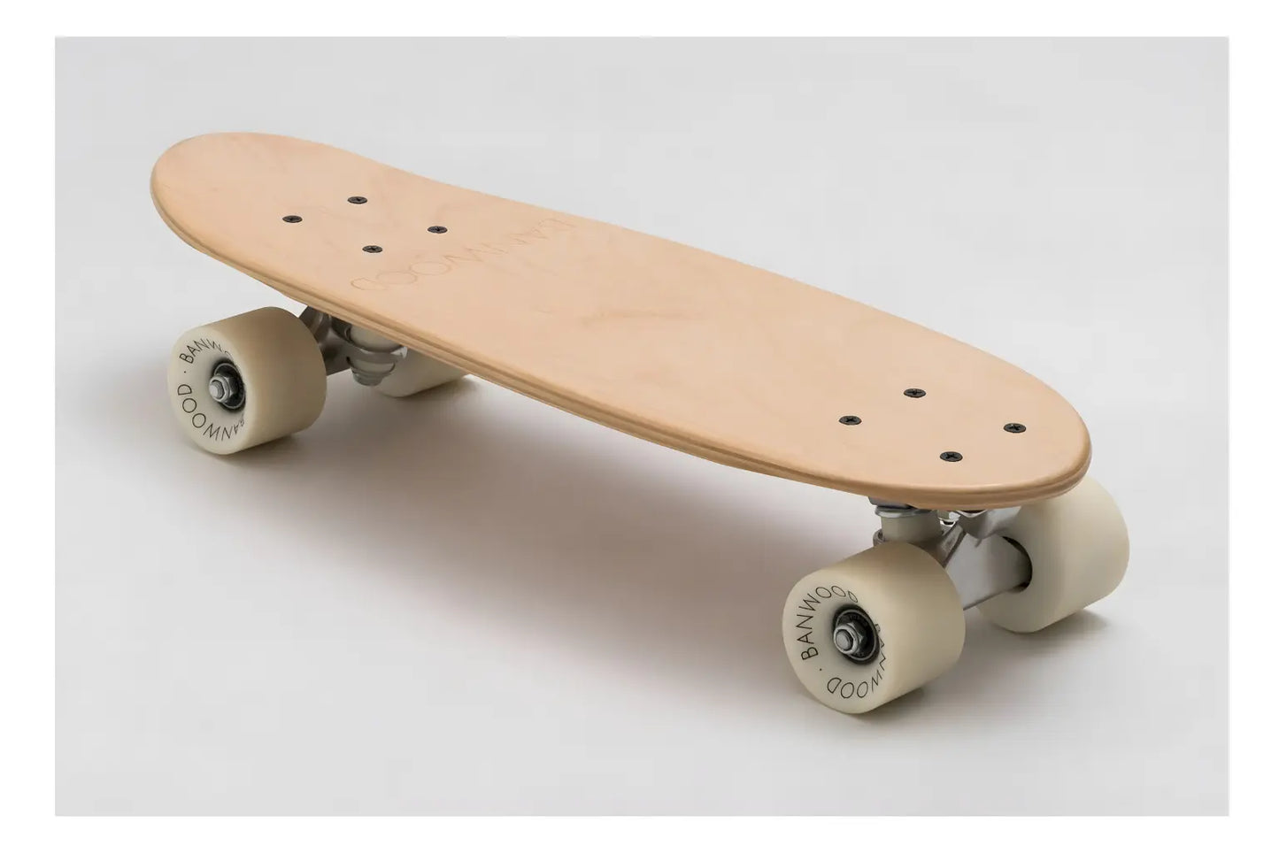 Wooden skateboard with white wheels on a light gray background