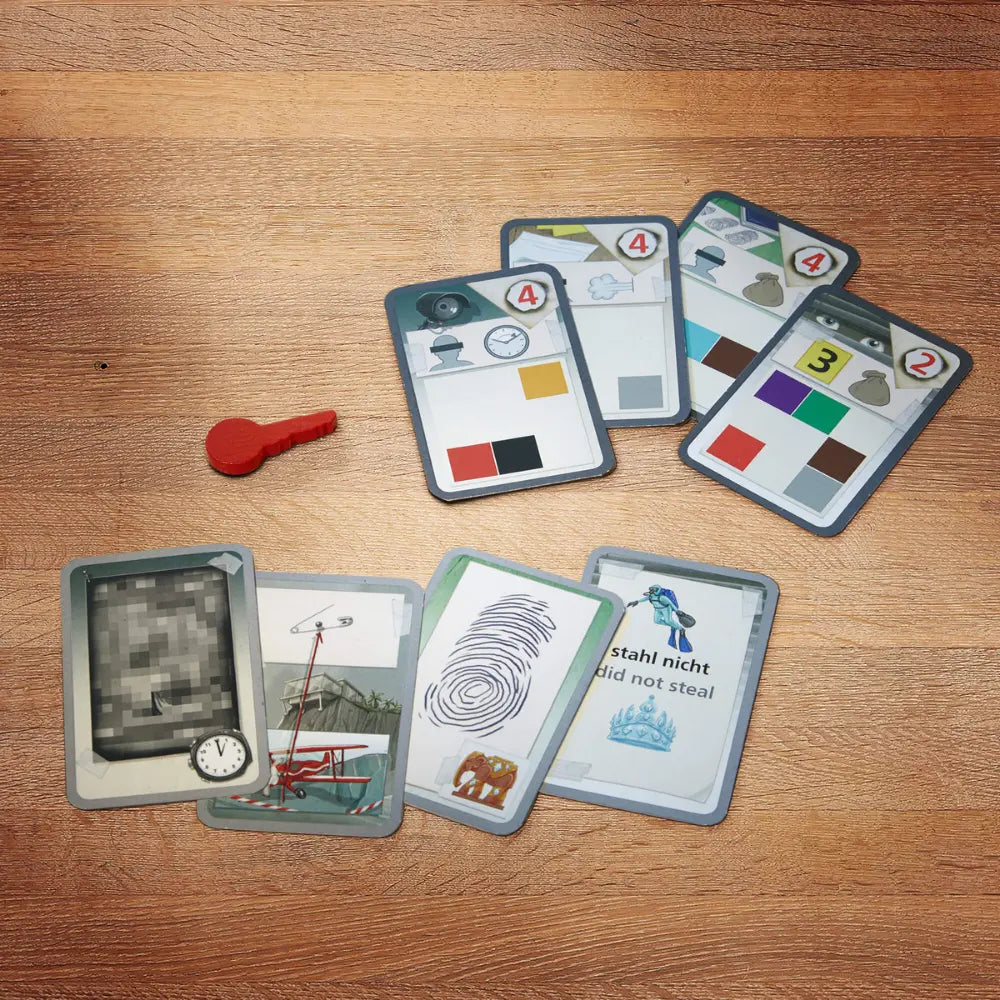 Collection of cards on a wooden surface with a red key.