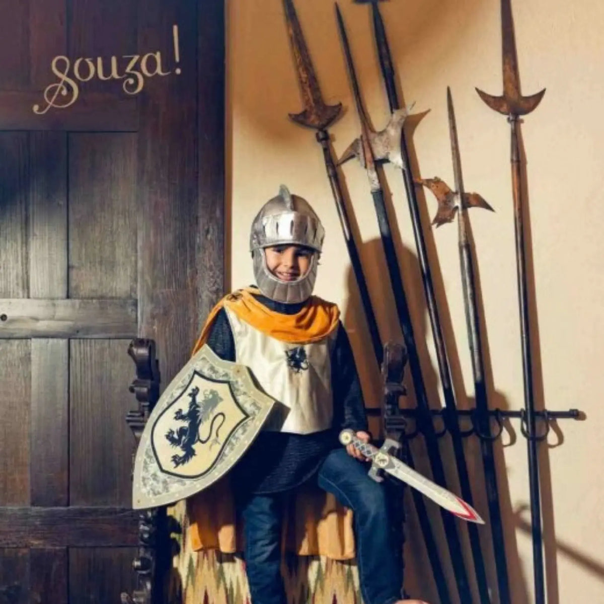Child wearing the Souza Ramon Knight Helmet with knight dress-up clothing for storybook and imaginative play