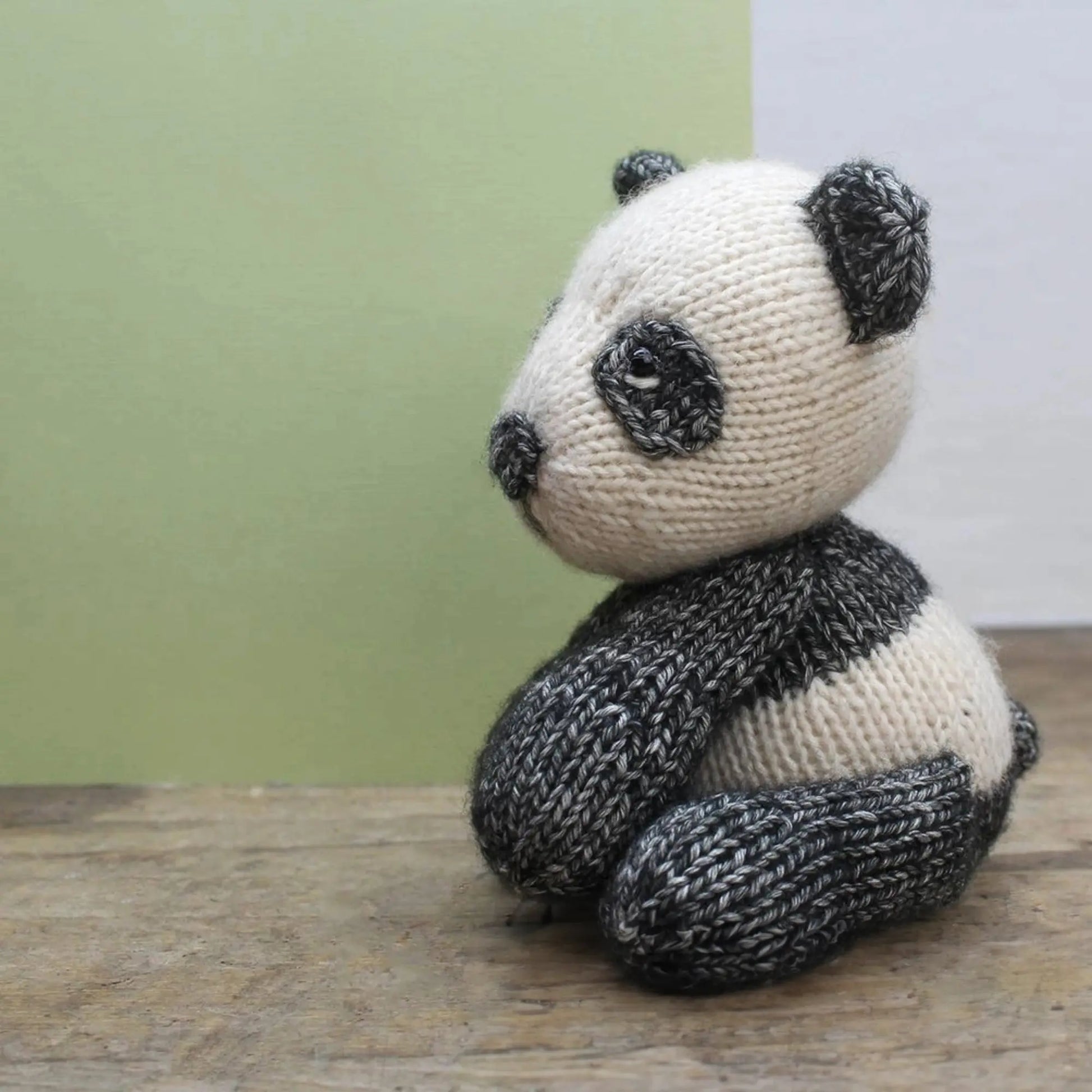 Side view of knitted panda bear stuffed animal