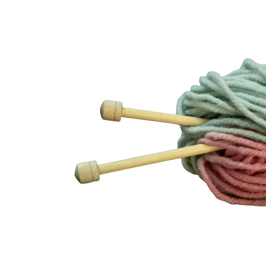 Knitting needles with yarn on a white background