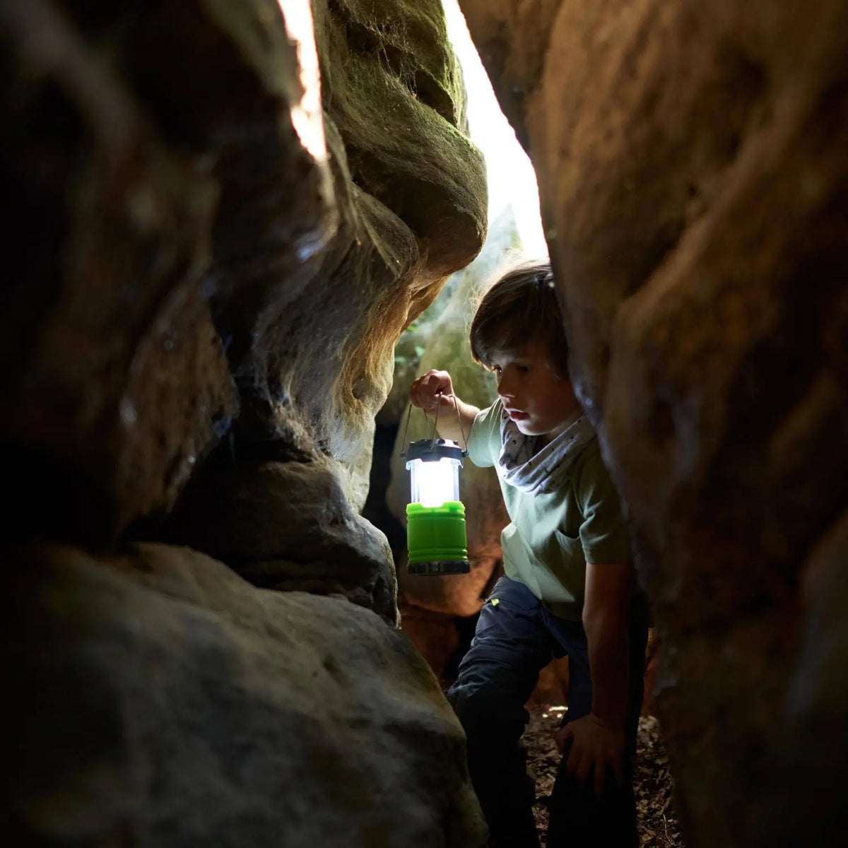 Child exploring with the illuminated HABA Terra Kids Camping Lantern
