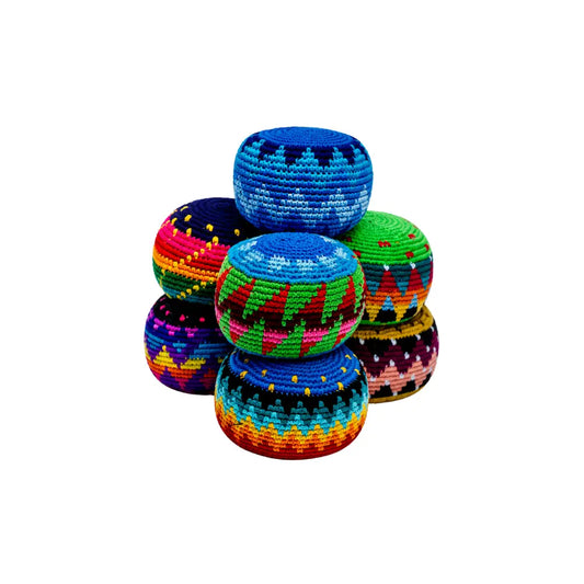 Stack of colorful large hacky sack foot sacks on a white background